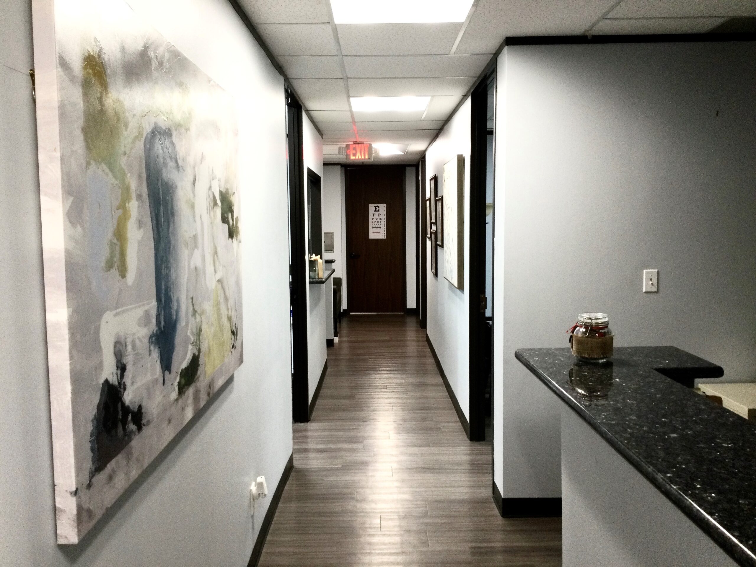 Office hallway with abstract painting and counter
